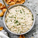 A bowl of easy Street Corn Dip surrounded by chips, ready to serve.