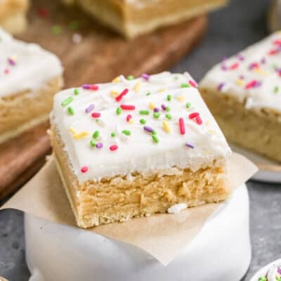 A sugar cookie bar with cream cheese frosting.