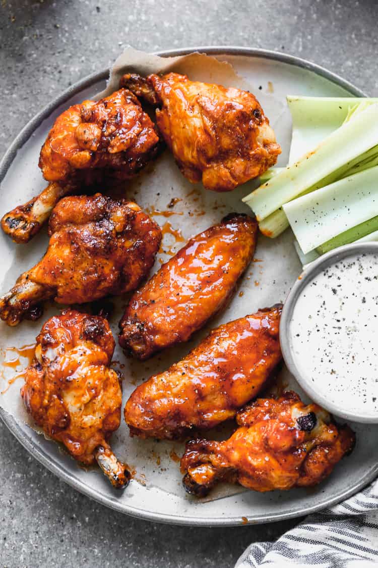 Baked Chicken Wings slathered in a buffalo sauce, ready to enjoy as an easy super bowl food.