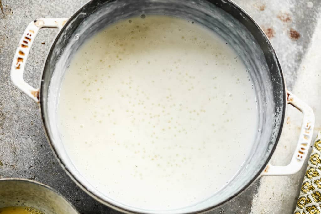 Tapioca pearls cooking in a pot with milk and sugar.