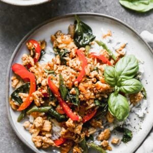 Thai Basil Chicken served with rice, on a plate.