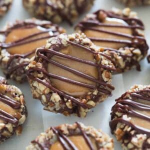 Turtle Thumbprint cookies on a baking sheet. | tastesbetterfromscratch.com