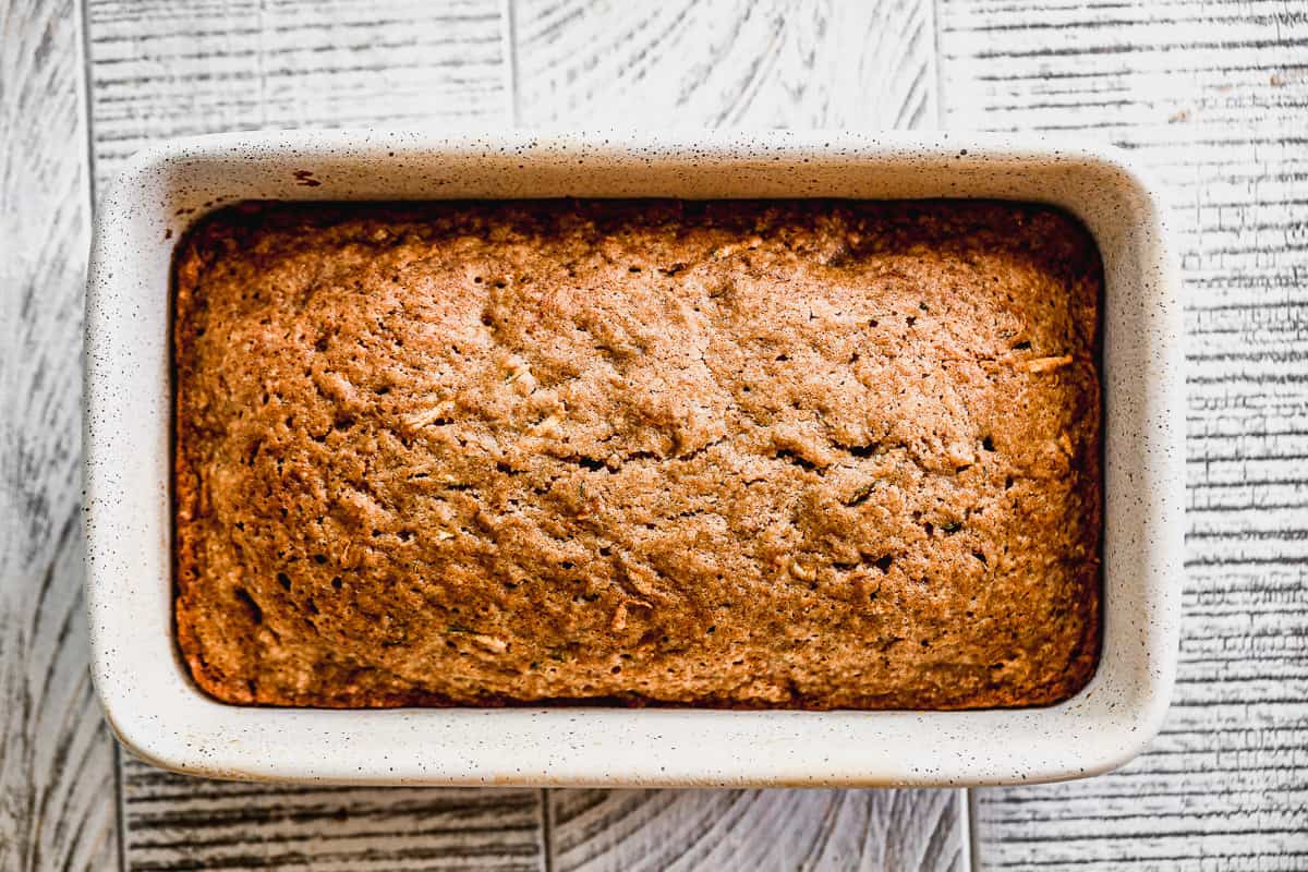 A loaf of baked zucchini bread, in the pan.